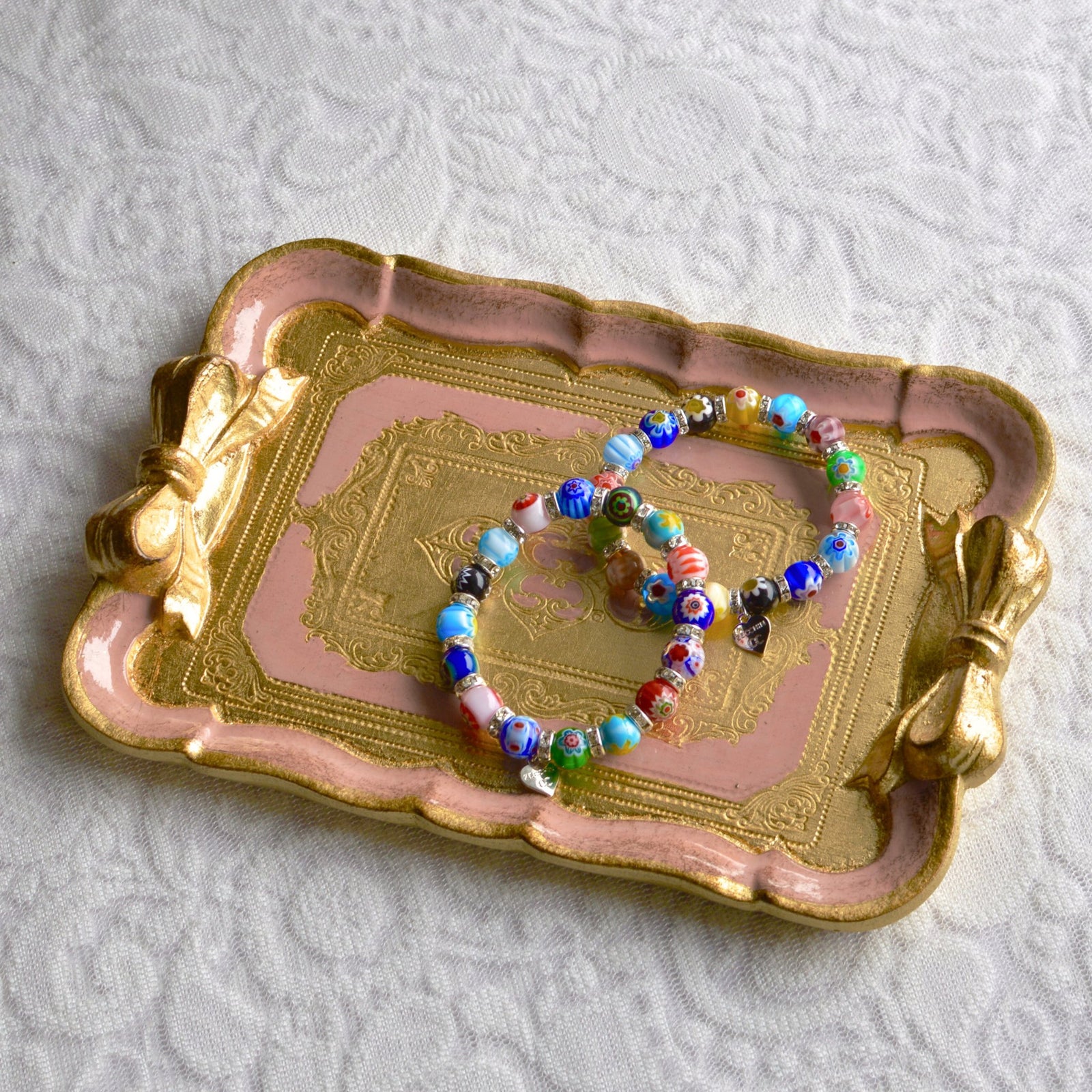 Decorative Florentine carved gilded wood tray with bow, made in Italy, featuring intricate design and vibrant colors.