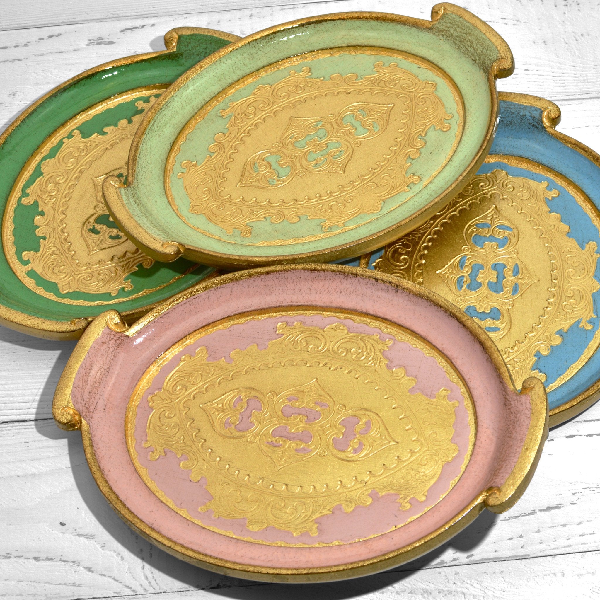 Decorative Florentine carved wood small oval tray with handles in multiple colors, ideal for display or serving.