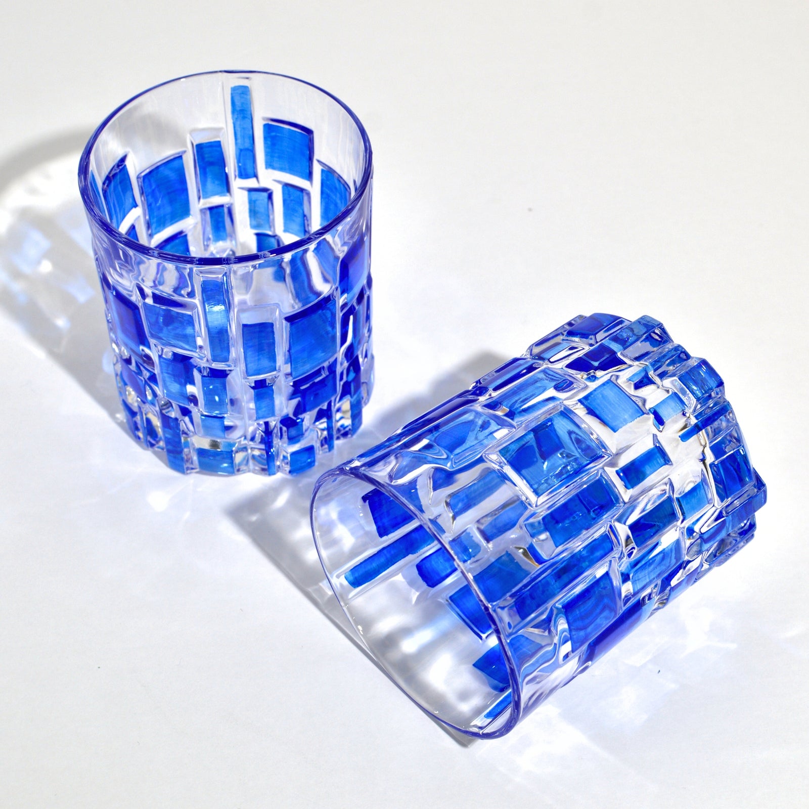 DZ Etna hand-painted Italian crystal tumblers, short sky blue glasses with intricate design, perfect for elegant beverage servings.