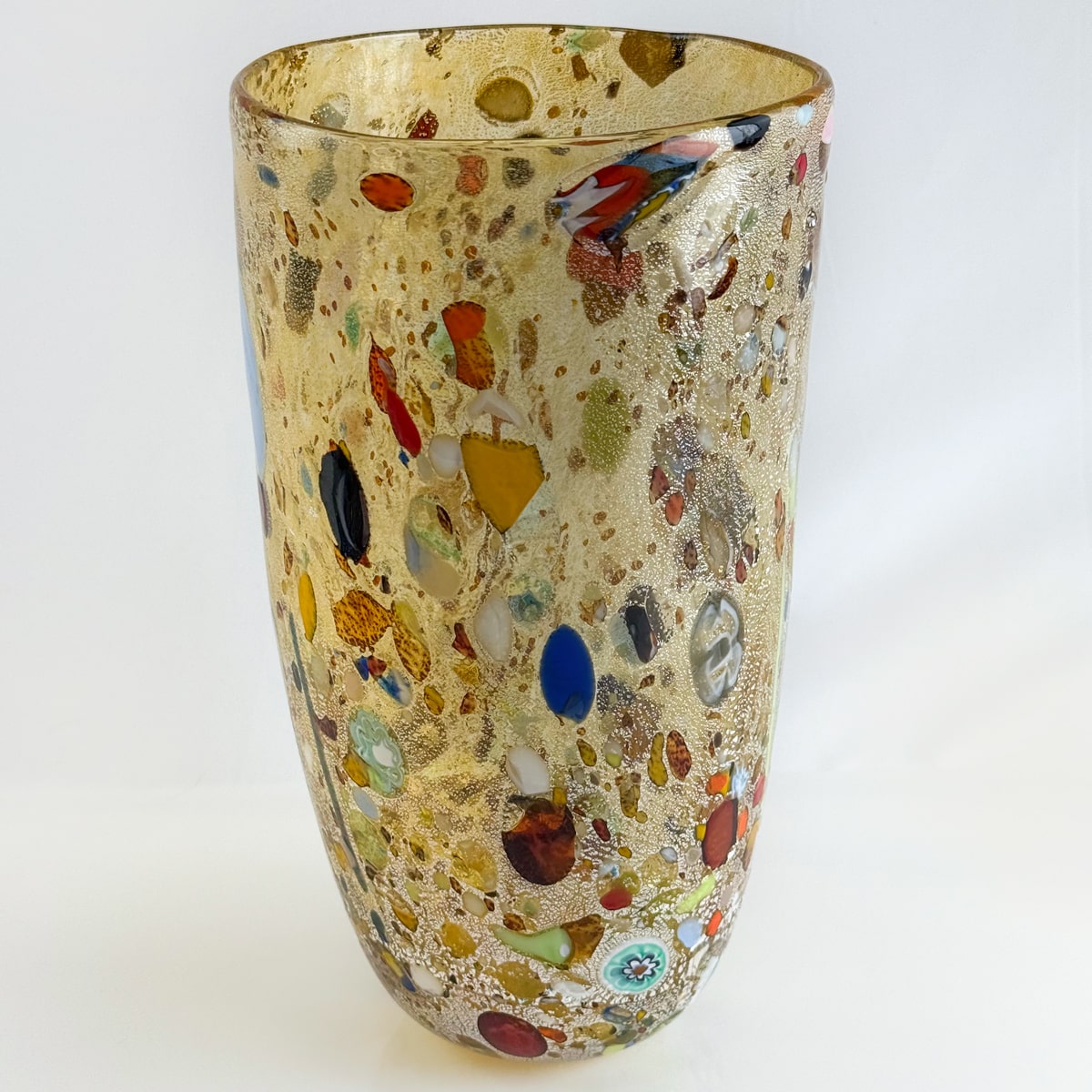 Decorative glass vase with multicolored speckles on a white background