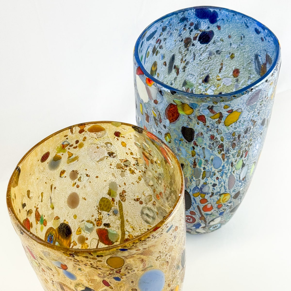 Two colorful glass vases with speckled patterns on a white background