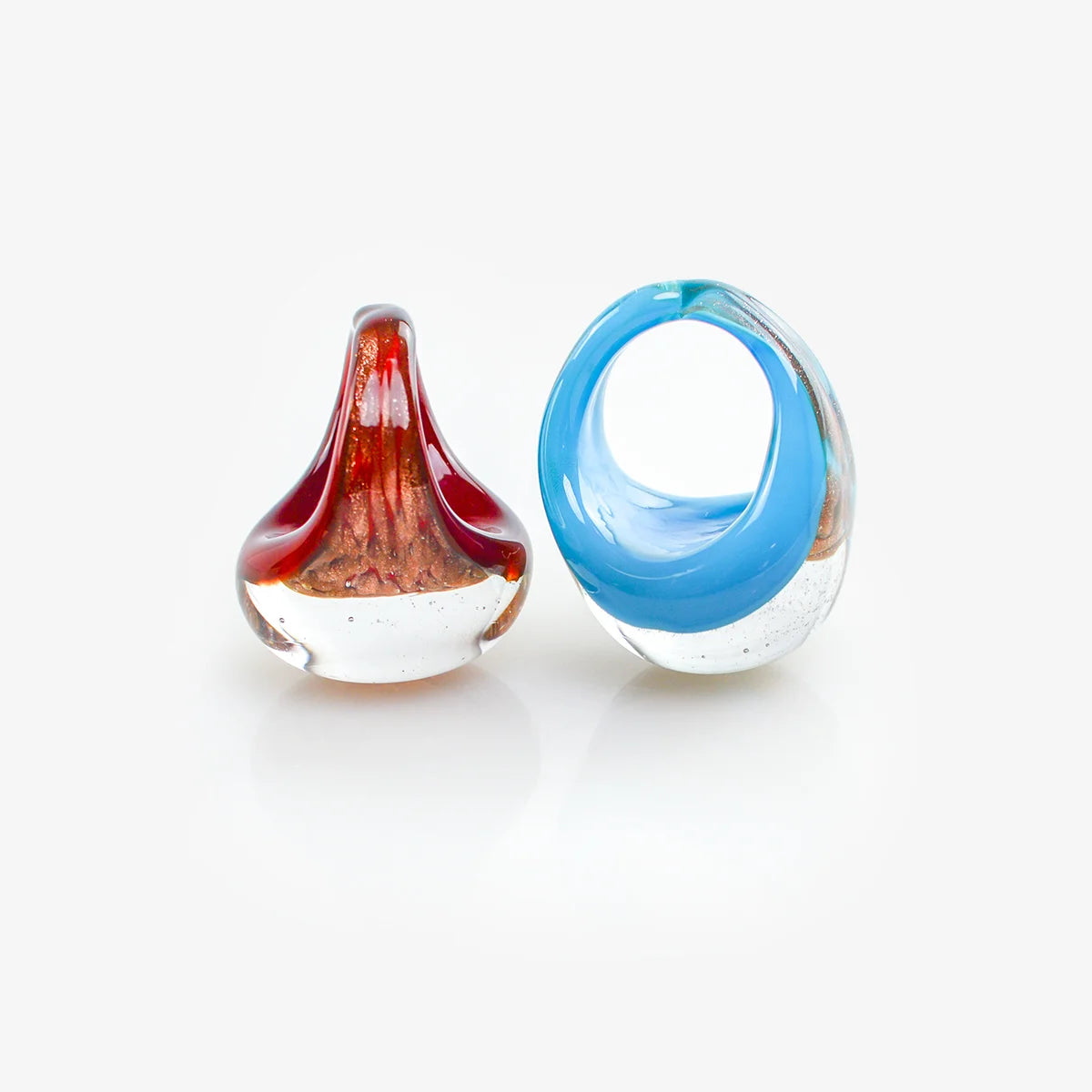 Two Murano glass rings with aventurina glitter, crafted in Italy, featuring vibrant blue and green hues, elegant and handcrafted.