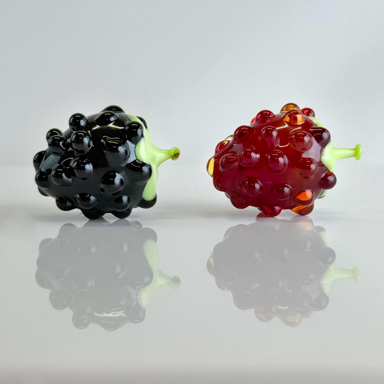 Set of three artificial Murano glass raspberry berries from MyItalianDecor, realistic and vibrant for decorative floral arrangements.