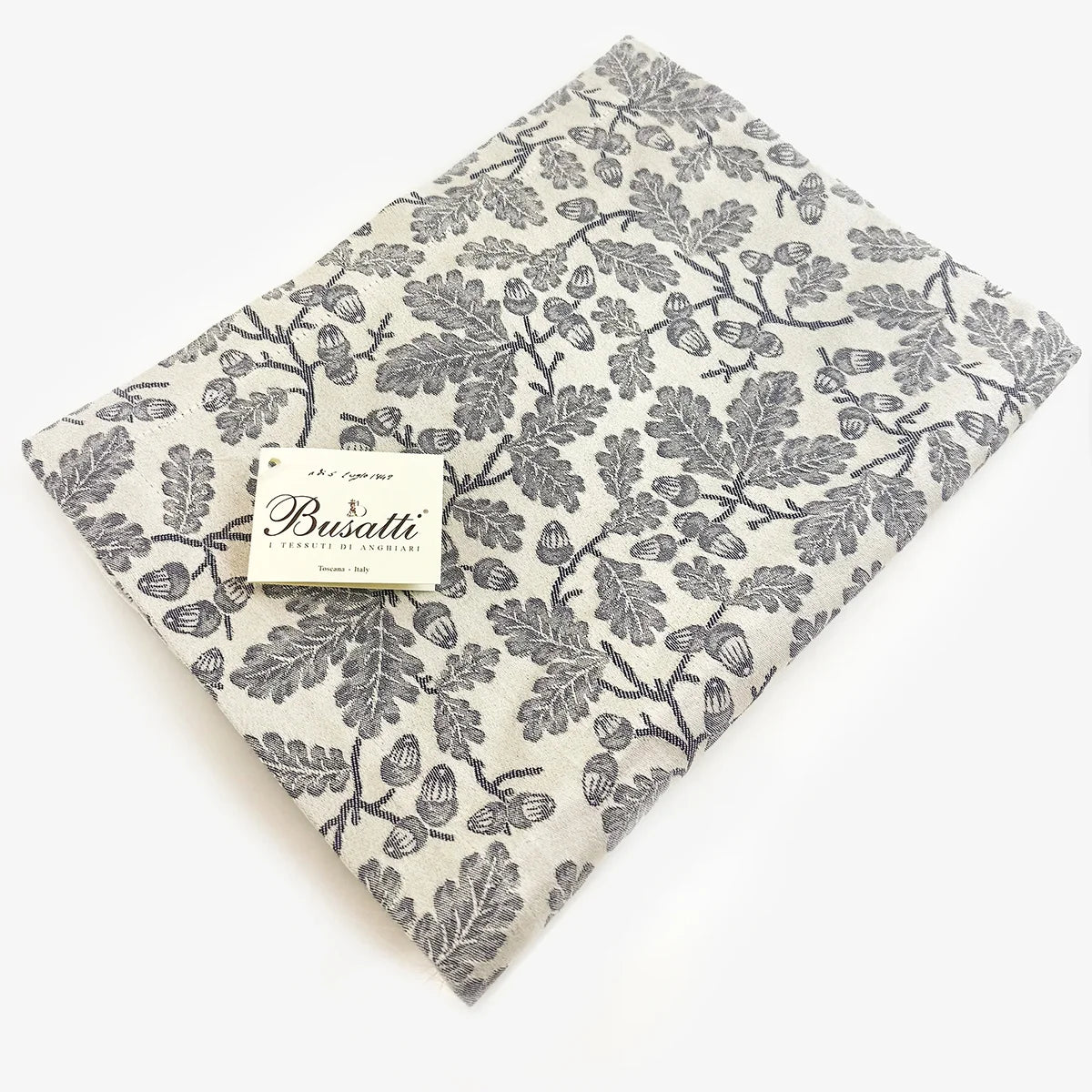 Busatti Acorn table runner made in Italy, featuring intricate woven design and natural linen fabric for elegant table decor.