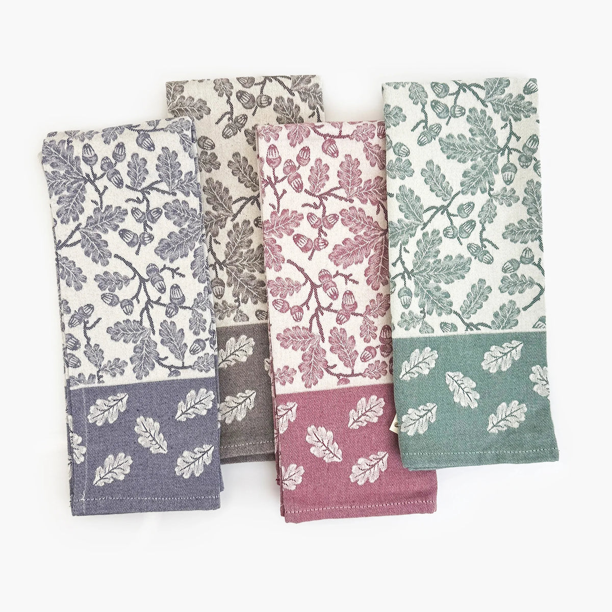 Busatti Acorn Kitchen Towel in assorted colors, made in Italy, displaying a woven fabric with a detailed acorn pattern.