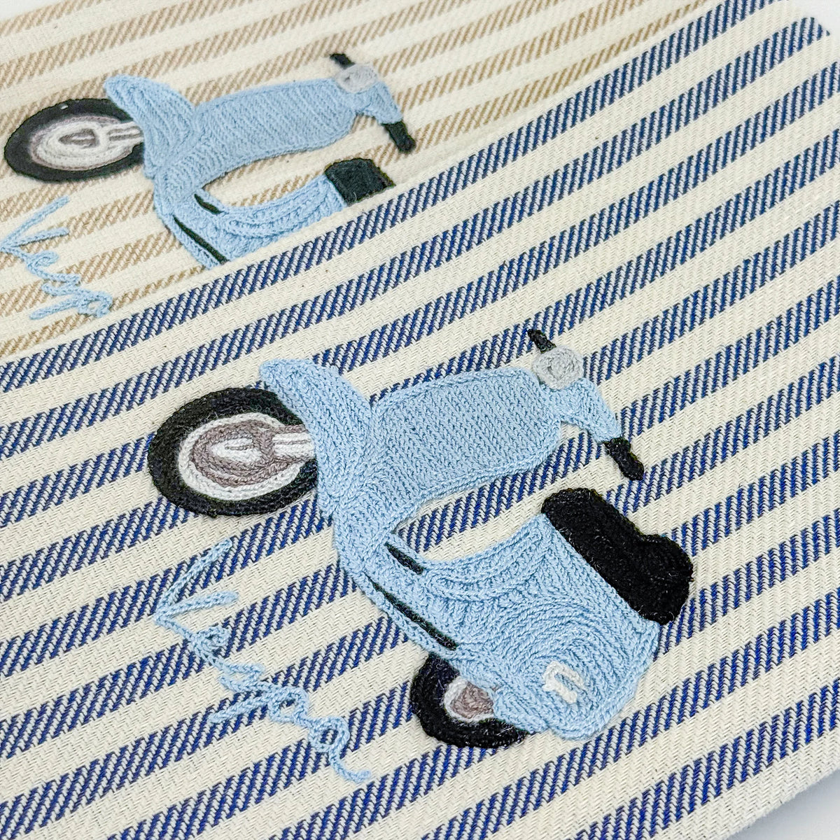 Busatti Vespa embroidered kitchen towel in assorted colors, made in Italy, featuring detailed Vespa scooter design on soft fabric.