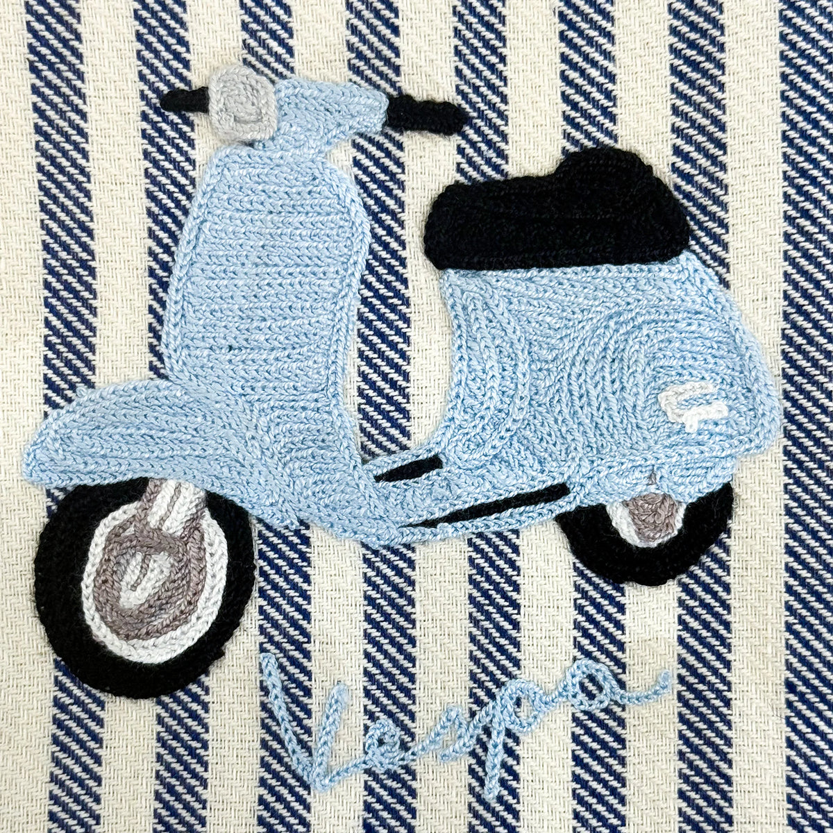 Busatti Vespa embroidered kitchen towel in assorted colors, made in Italy, showcasing intricate embroidery and vibrant fabric.