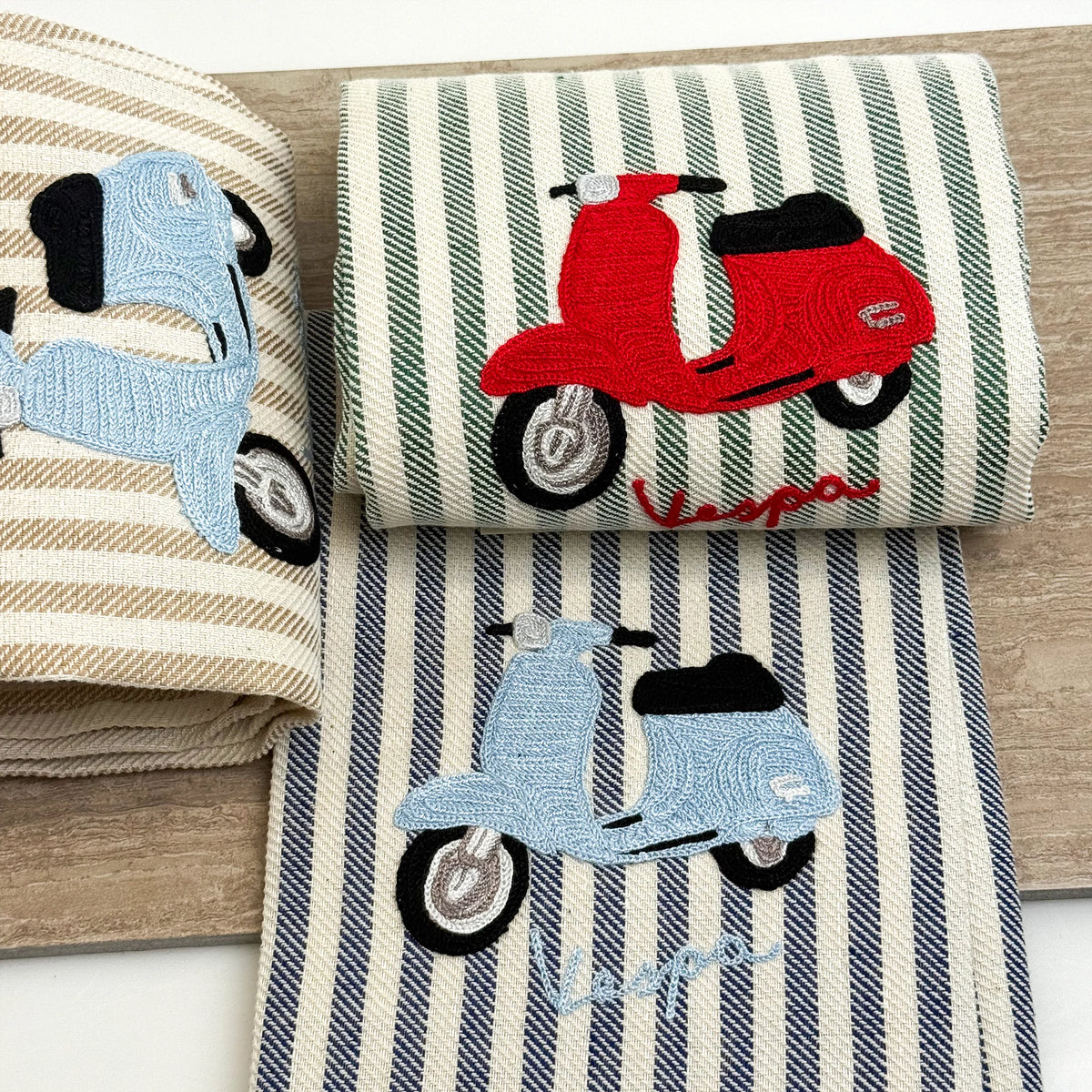 Busatti Vespa embroidered kitchen towel in assorted colors, made in Italy, featuring detailed Vespa scooter embroidery for stylish kitchen decor.