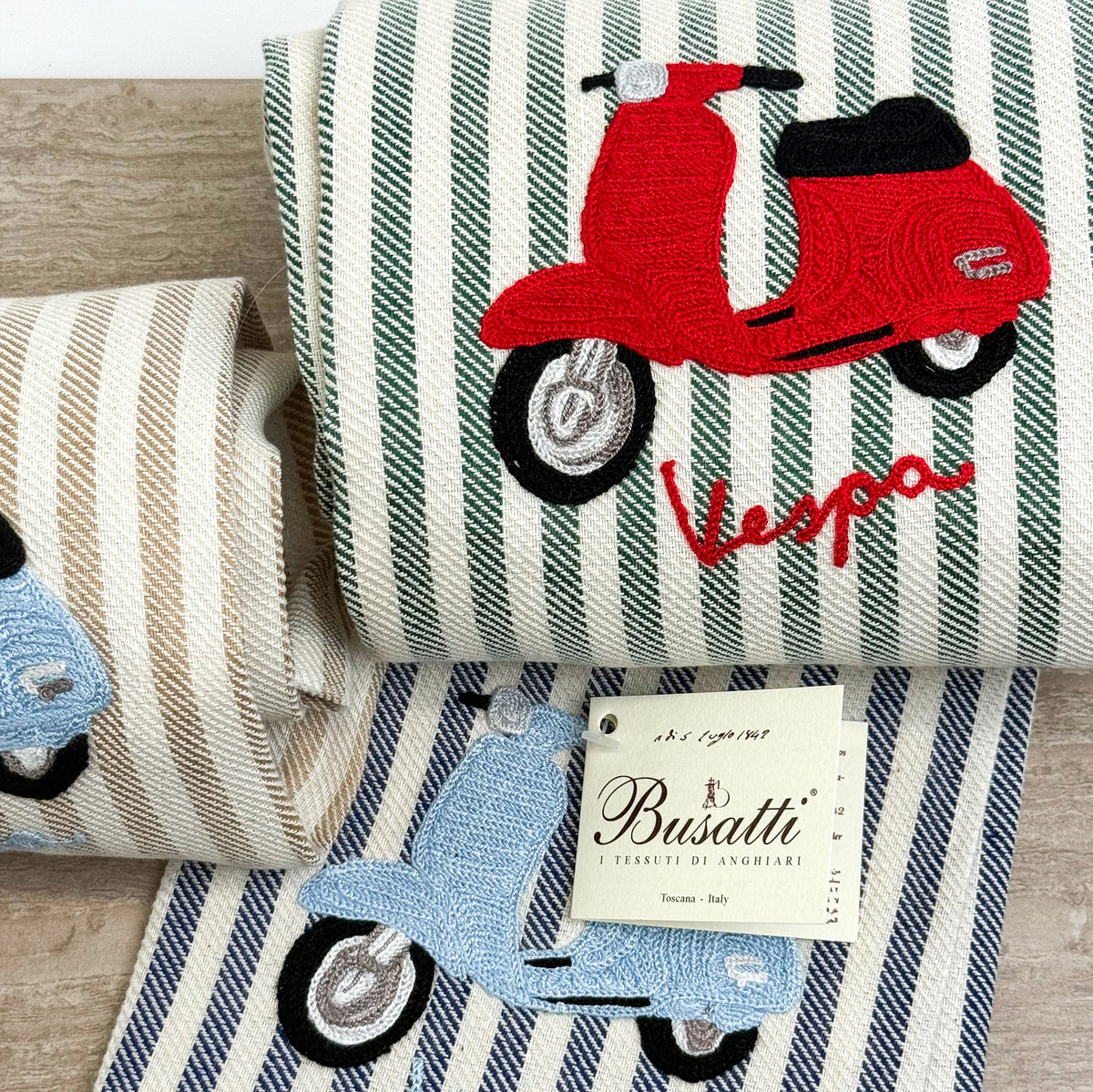 Busatti Vespa embroidered kitchen towel with colorful Vespa scooter design, made in Italy, featuring vibrant assorted colors.