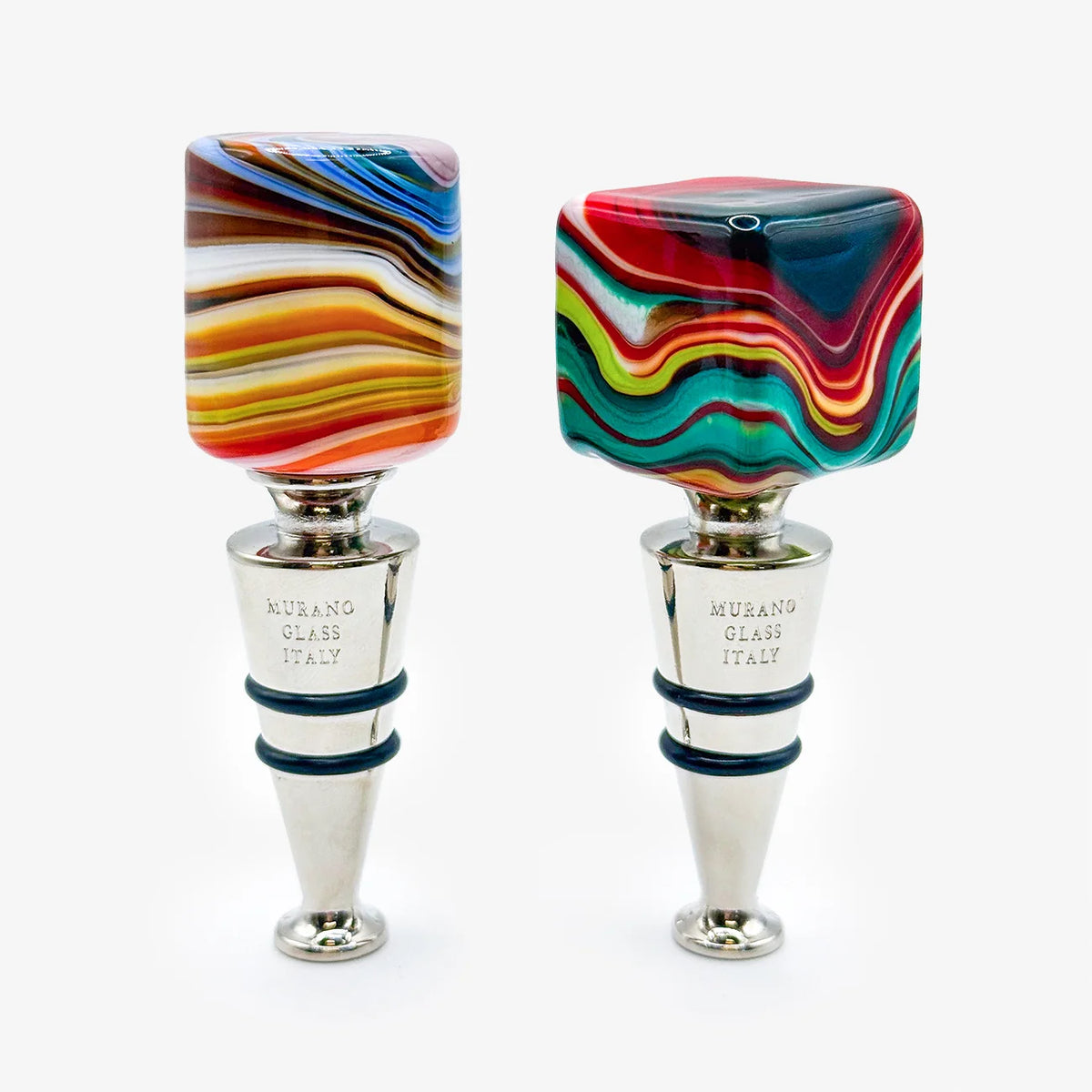 Two Murano glass wine stoppers with colorful swirled tops and polished silver metal bases, displayed side by side on a light gray background.