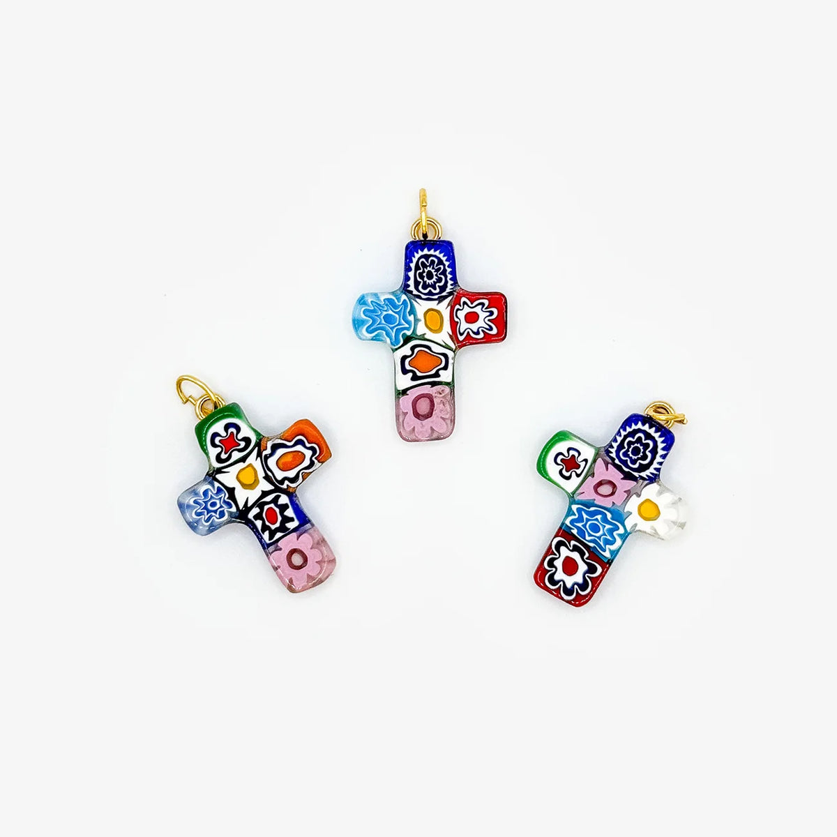 Millefiori cross pendant made in Italy, featuring colorful glass mosaic design, hanging on a delicate chain.
