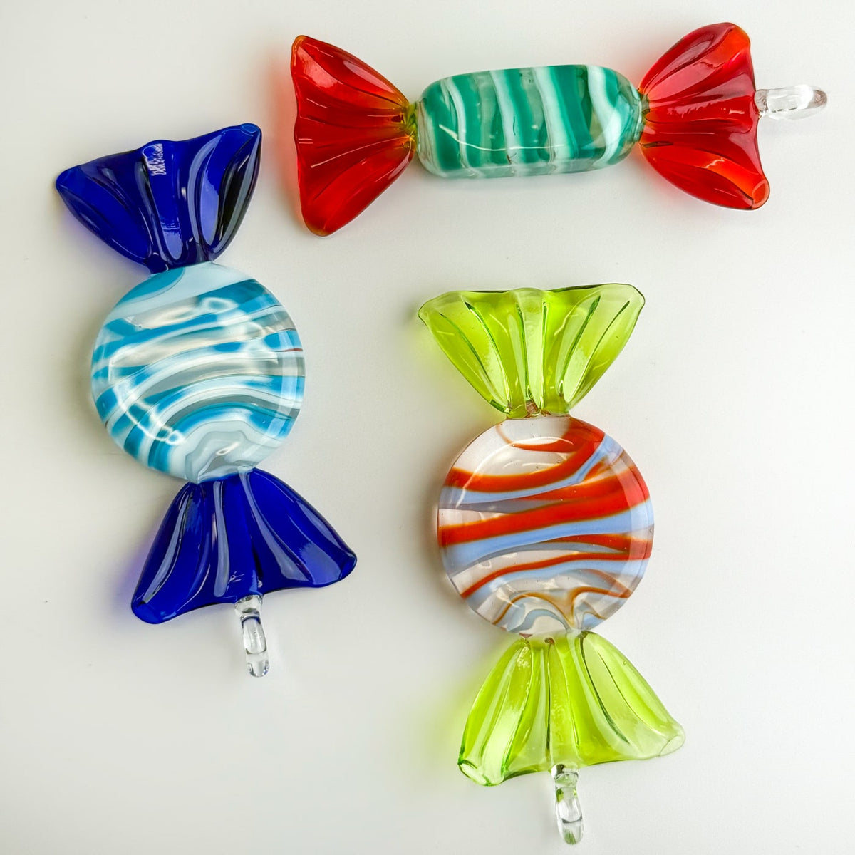 Colorful glass candy ornaments on a white background