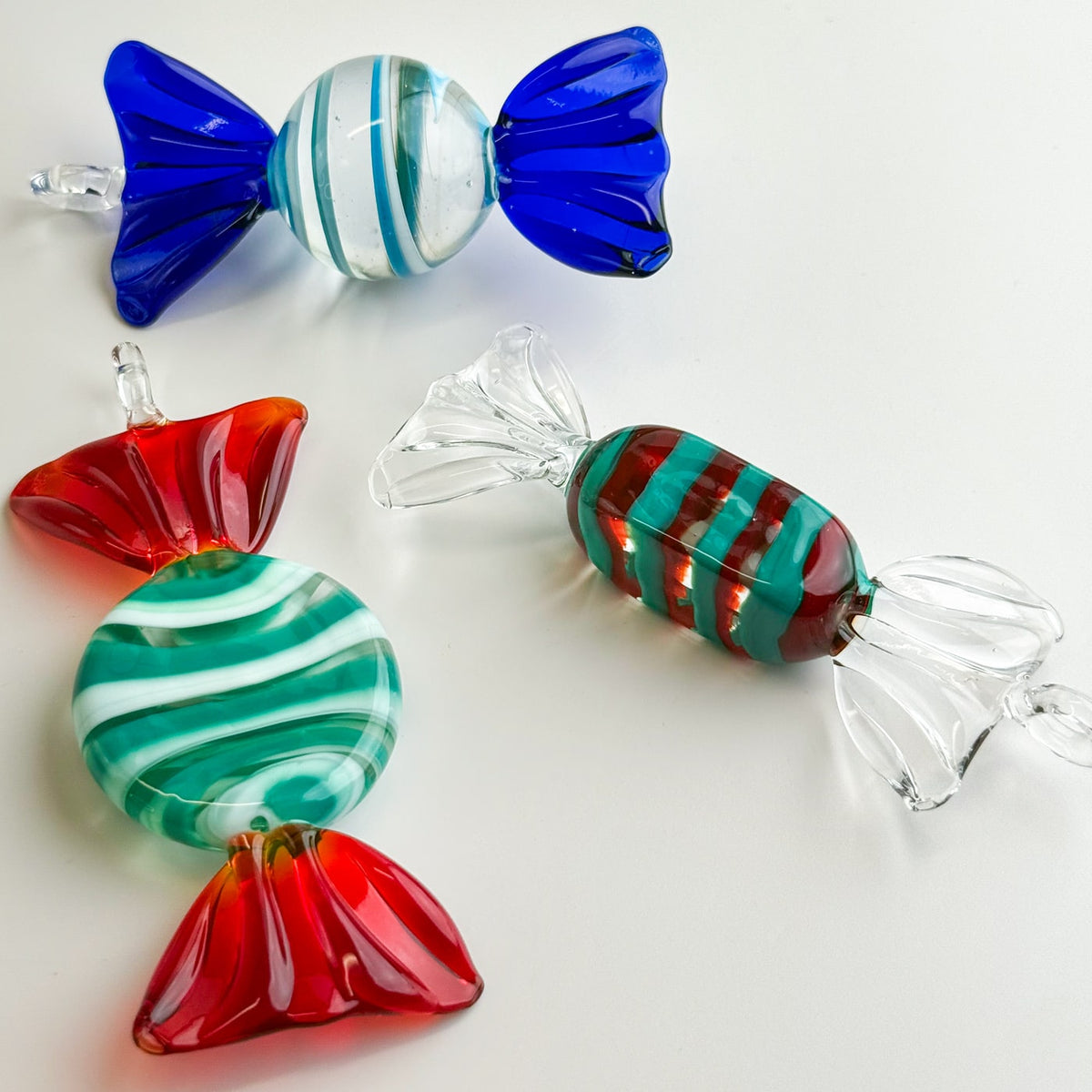 Colorful glass candy ornaments on a white background