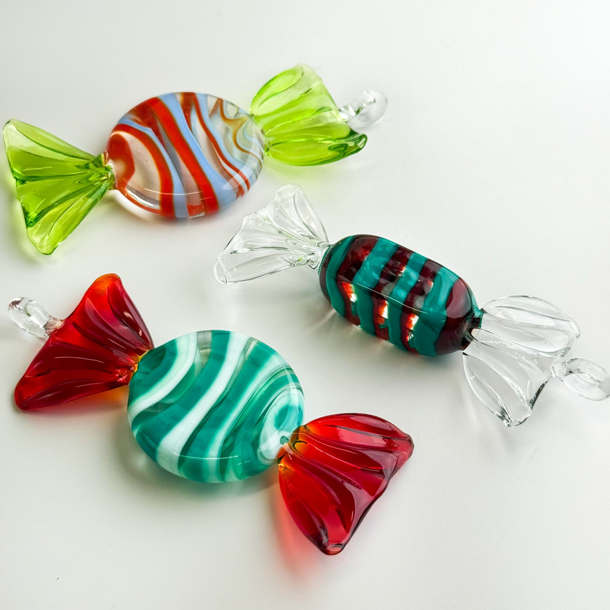 Colorful glass candy ornaments on a white background