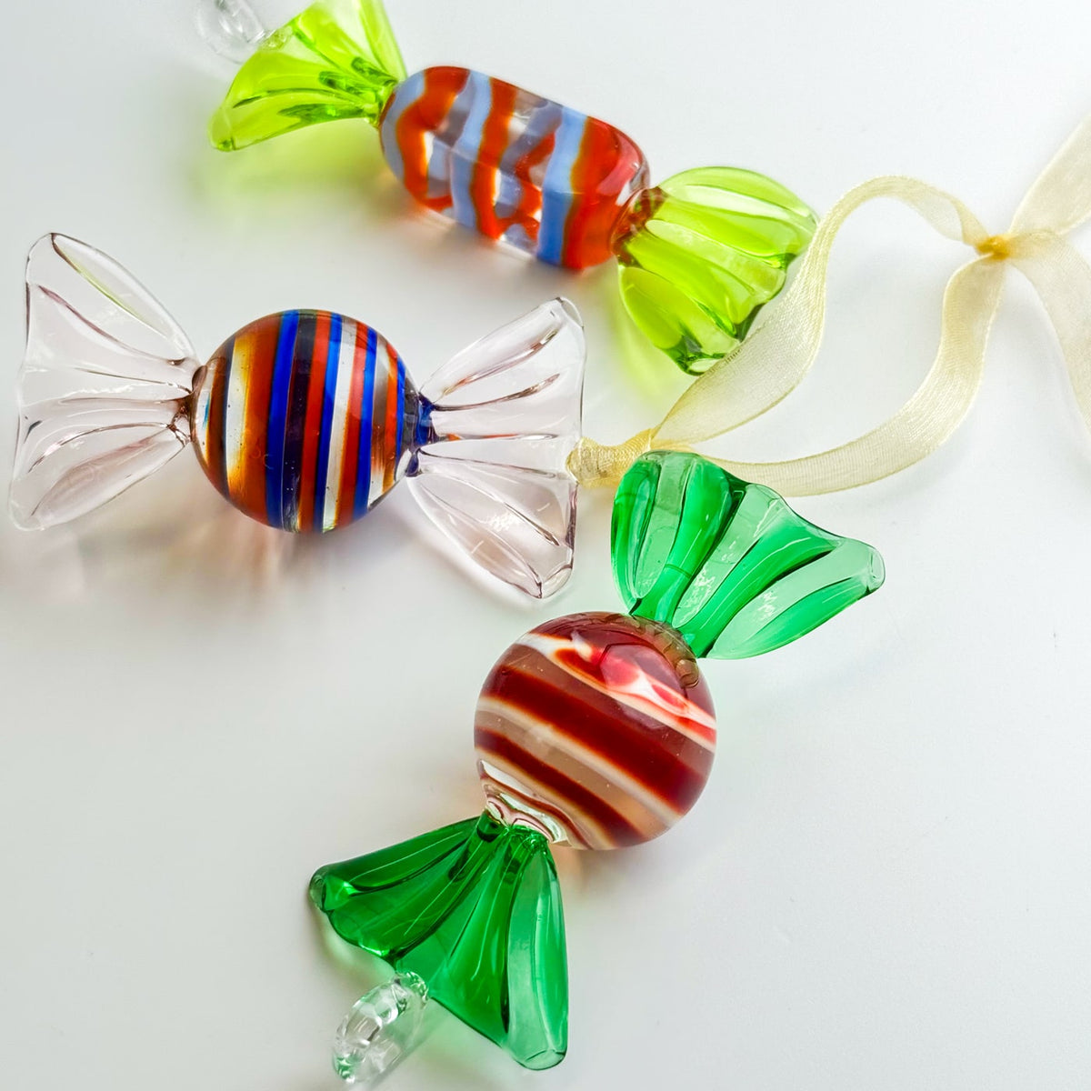 Colorful glass candy ornaments on a white background