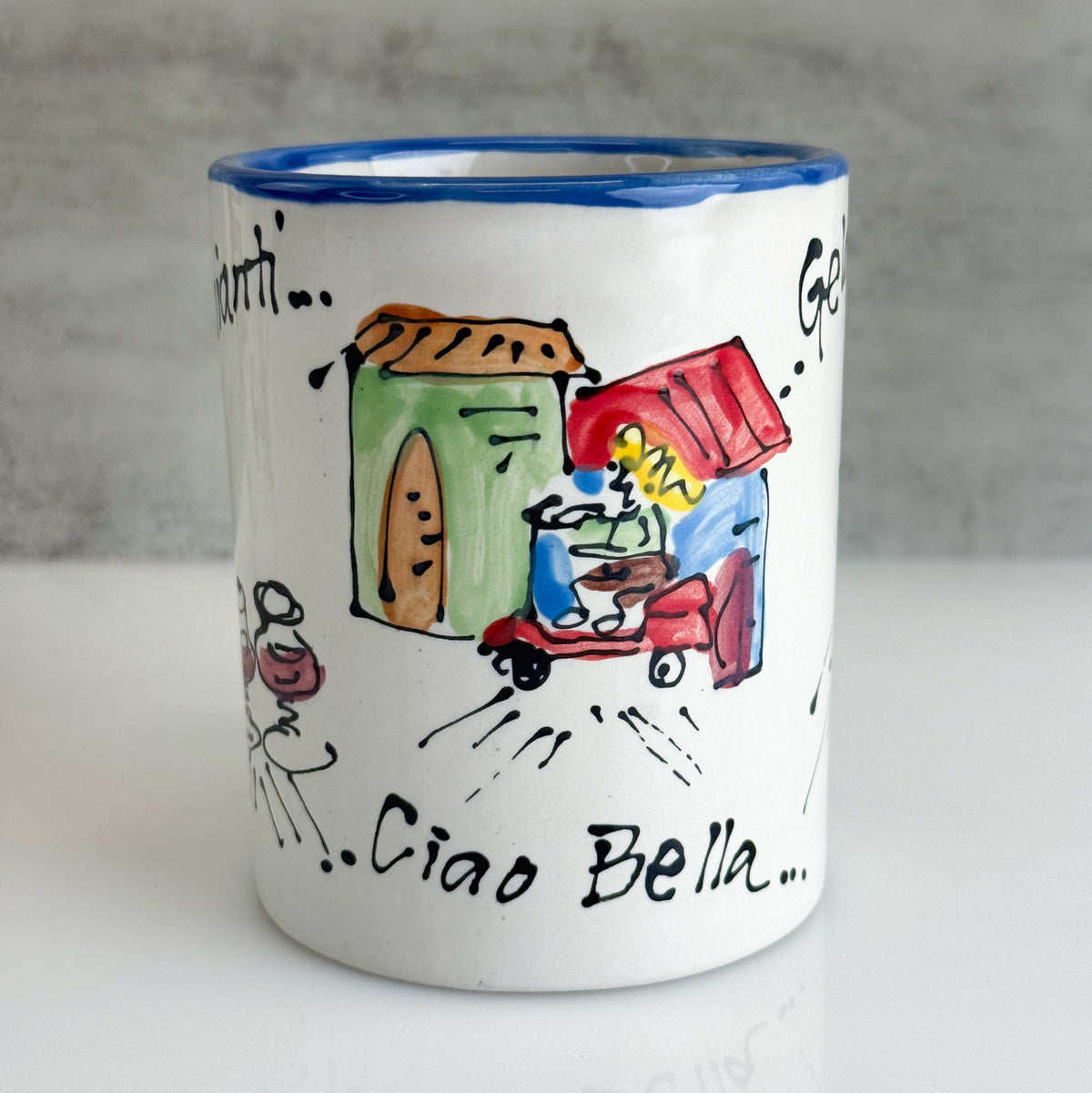 White mug with colorful illustrations and text on a gray background