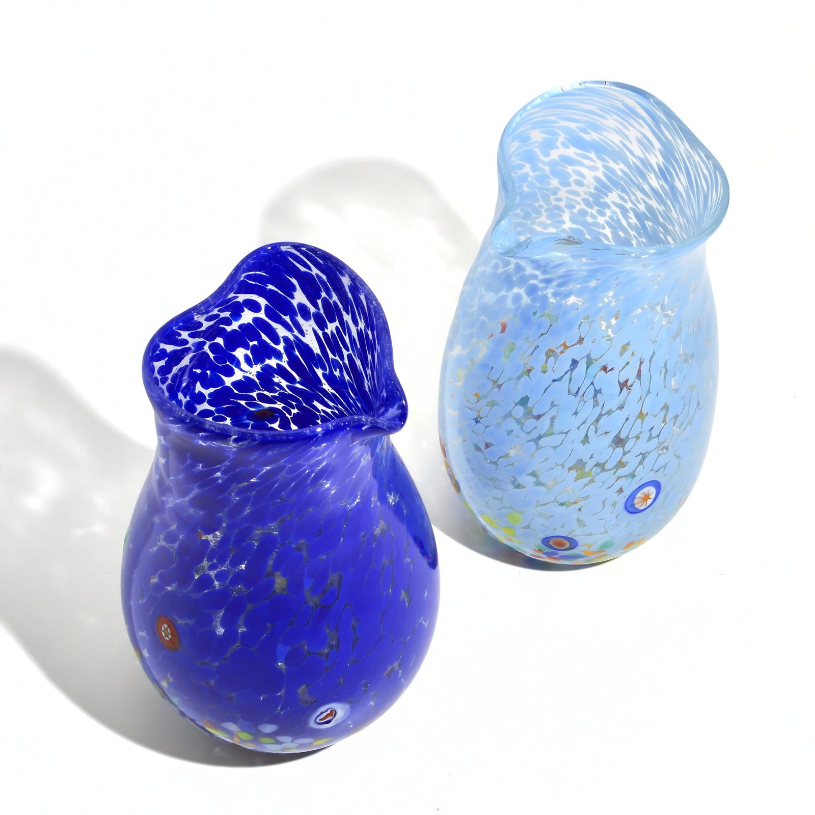Heart-shaped Murano glass drink carafe with Millefiori design, made in Italy, featuring vibrant colors and intricate glasswork.