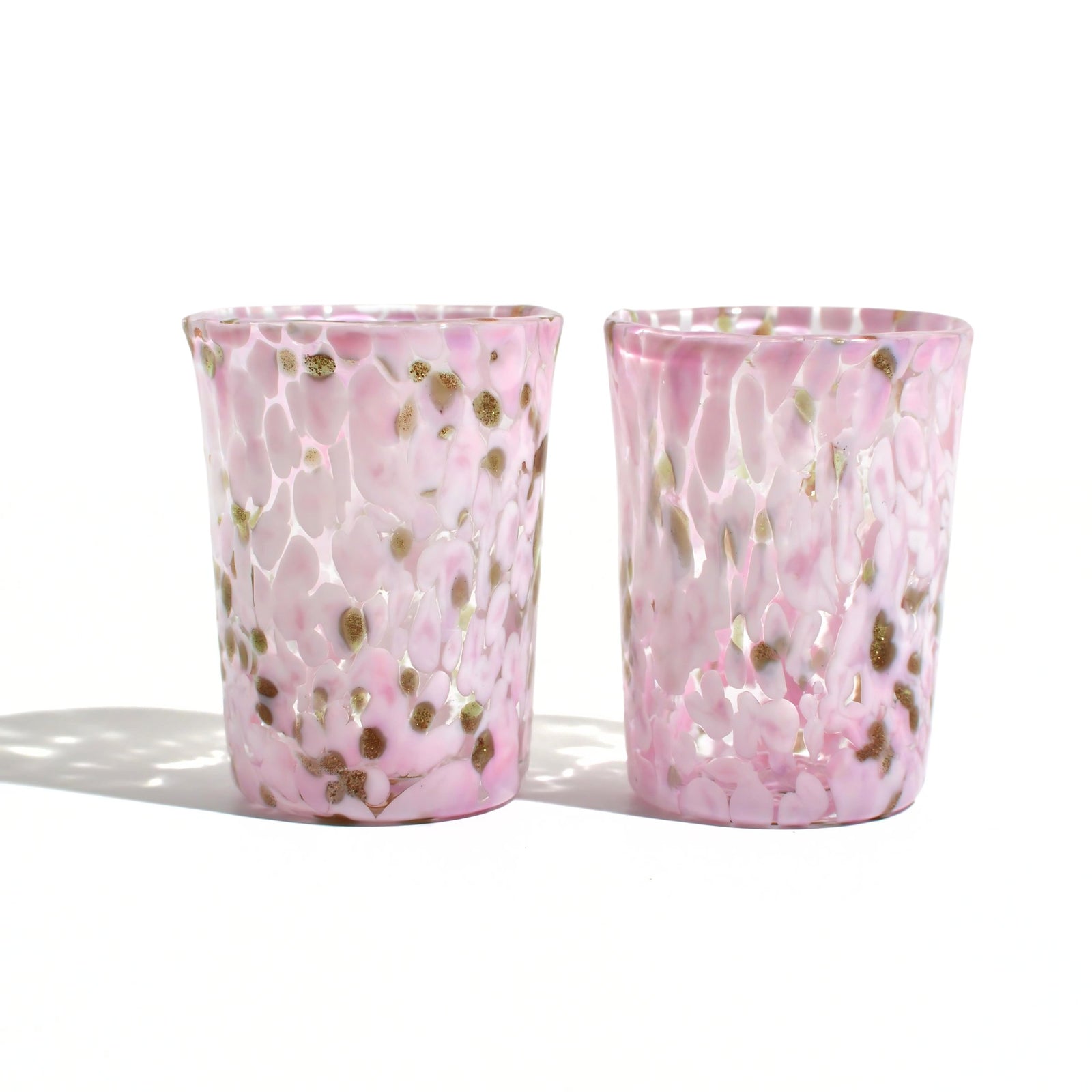 Stacked Murano Glass Tesoro shot glasses from Italy with colorful, intricate designs, showcasing artisanal craftsmanship and vibrant patterns.