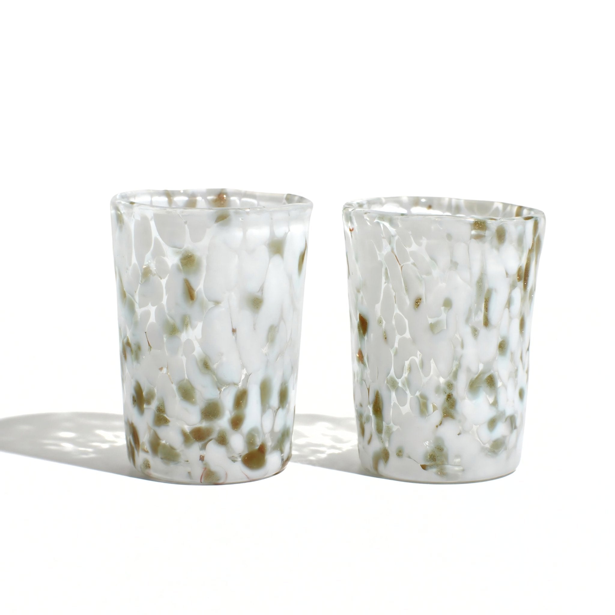 Set of two white Murano glass Tesoro shot glasses by MyItalianDecor, made in Italy, showcasing intricate glass craftsmanship.