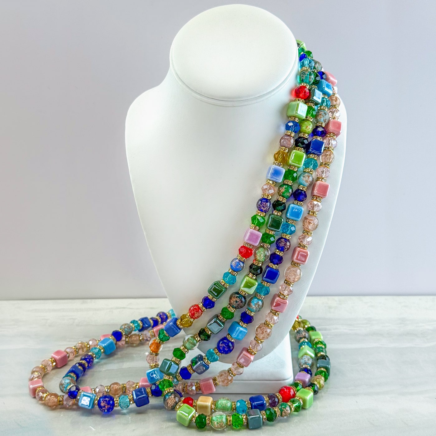 Multicolor beaded necklace and bracelet set by DZ, featuring vibrant beads in a stylish jewelry set design.