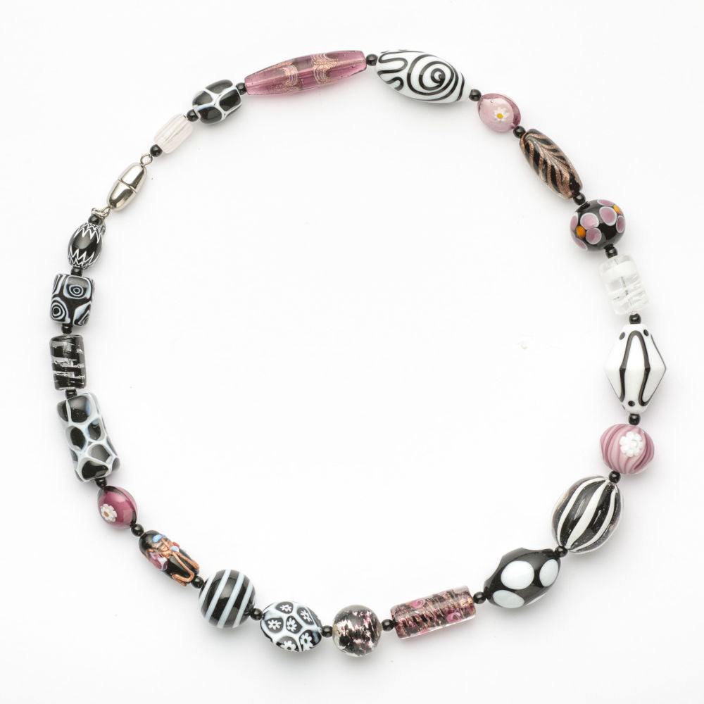 Colorful Murano glass necklace with melting pot design in white, black, and pink, featuring handcrafted Italian glass artistry.