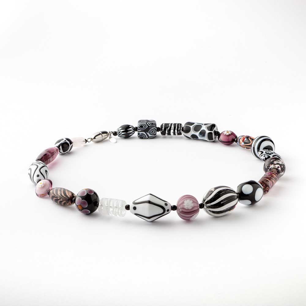 White, black, and pink Murano glass melting pot necklace featuring vibrant, handcrafted beads on a stylish necklace.