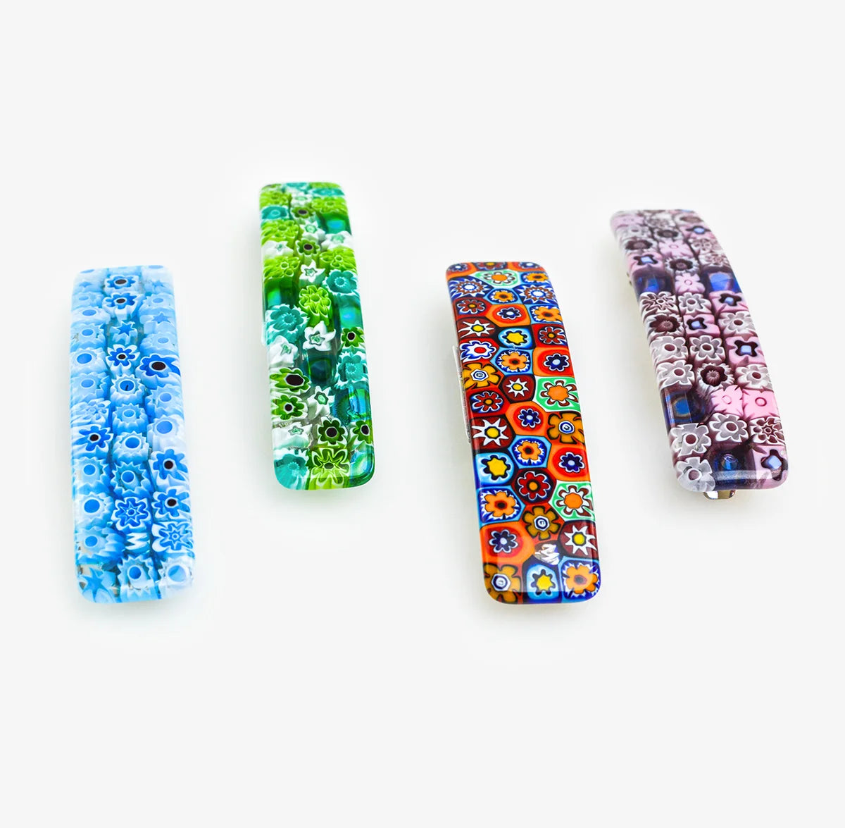 Colorful Millefiori Murano glass barrettes by My Italian Decor with intricate floral patterns on clear glass.