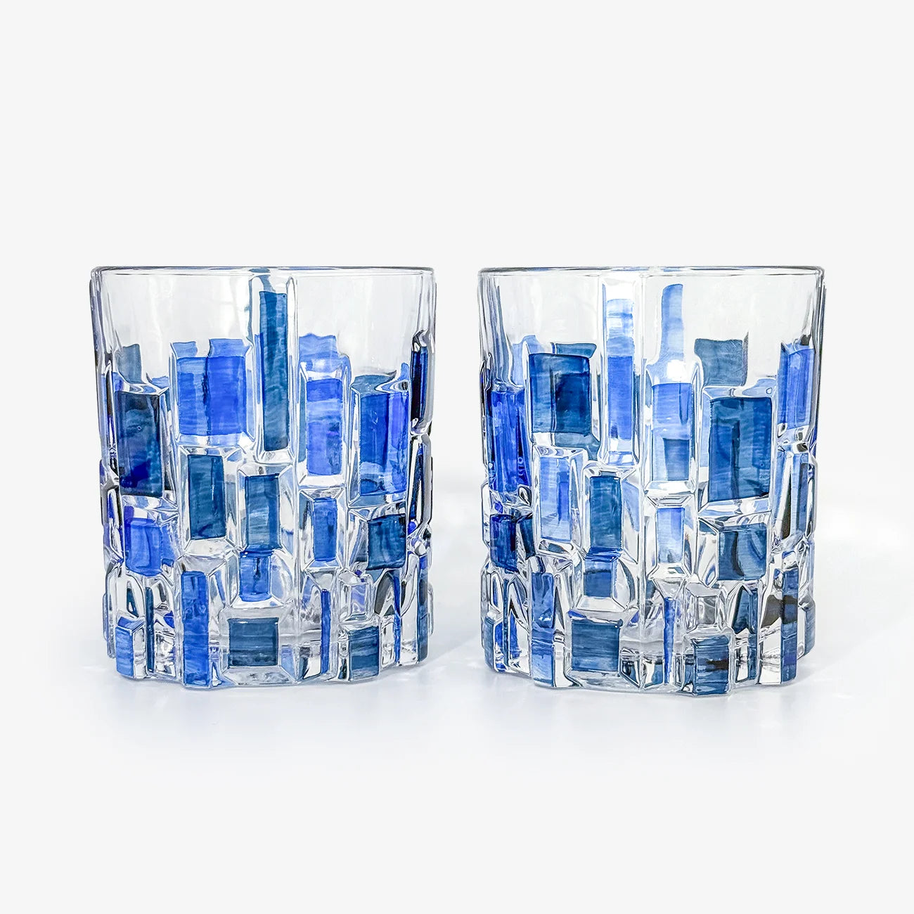 Pair of Etna hand-painted Italian crystal tumblers in two-toned blue with intricate designs, perfect for elegant drinkware.