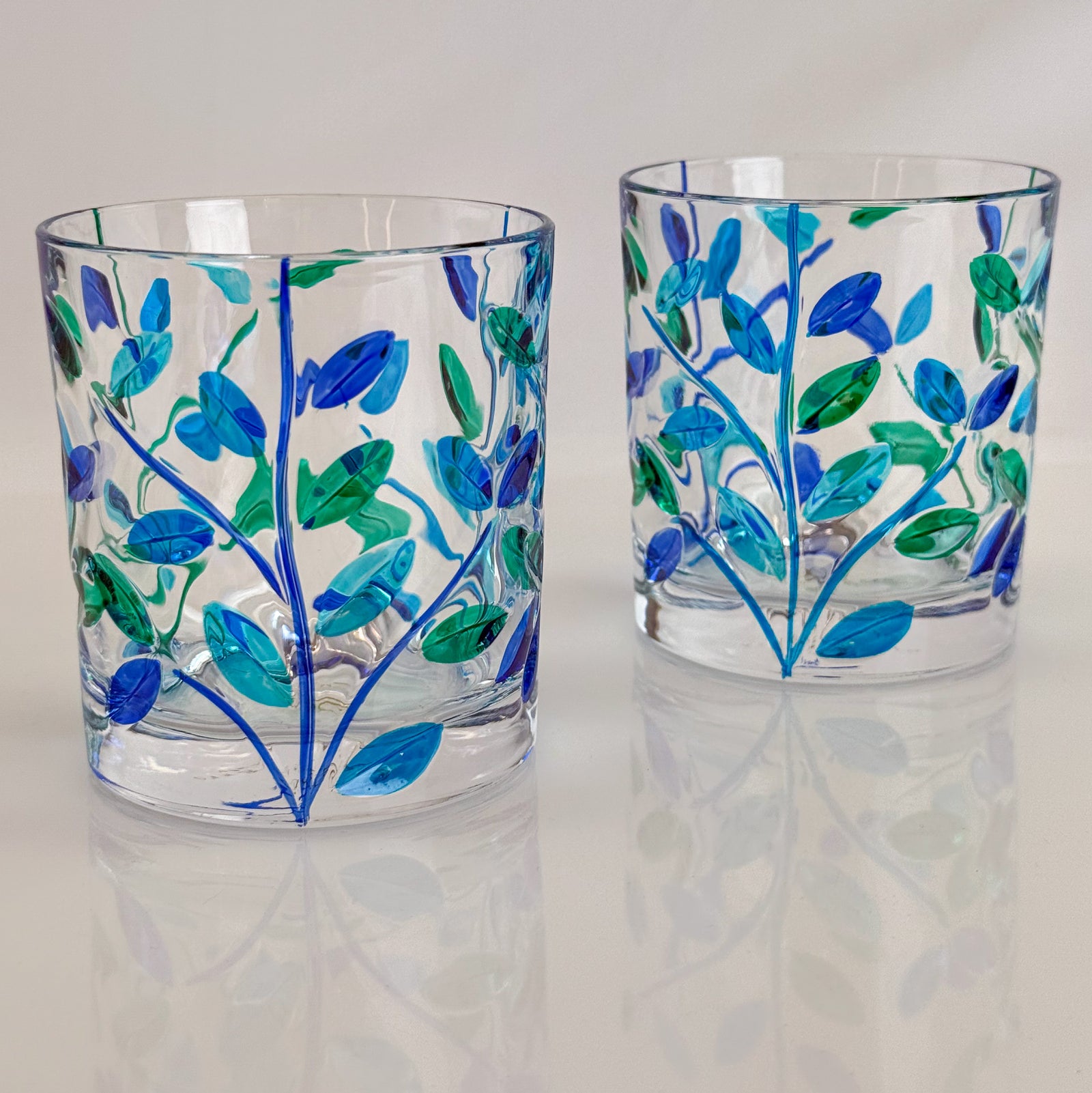 Set of 2 Flowervine blue and green glass tumblers by DZ, short drink glasses made in Italy, with elegant floral design.