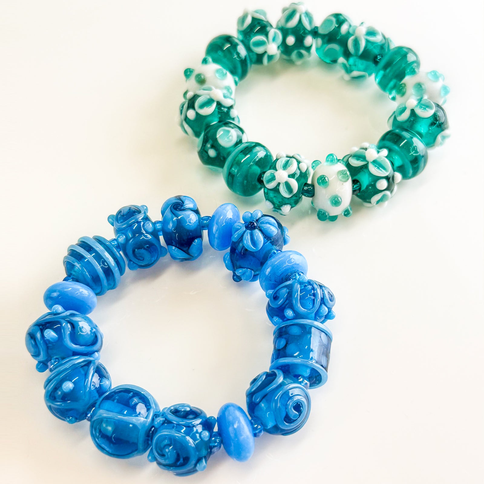Turquoise floral bead bracelet and earrings set with Murano glass beads and fruit-inspired designs, crafted by Crazy 4 Glass.