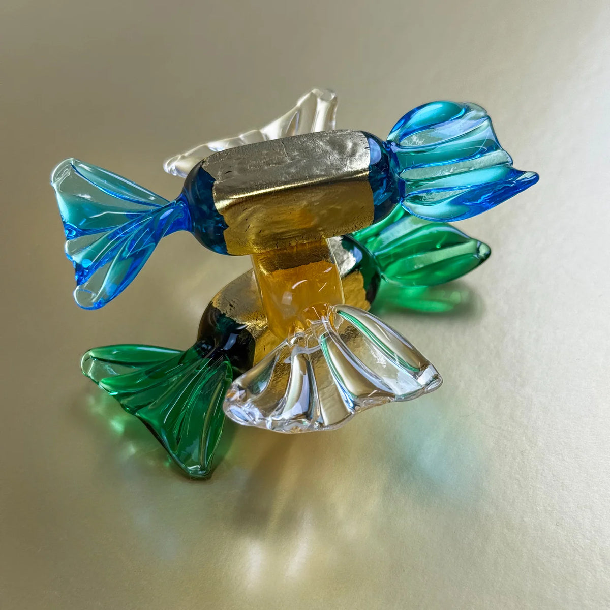 Set of gold Murano glass candy artificial food pieces, crafted to resemble realistic candy for decorative purposes.