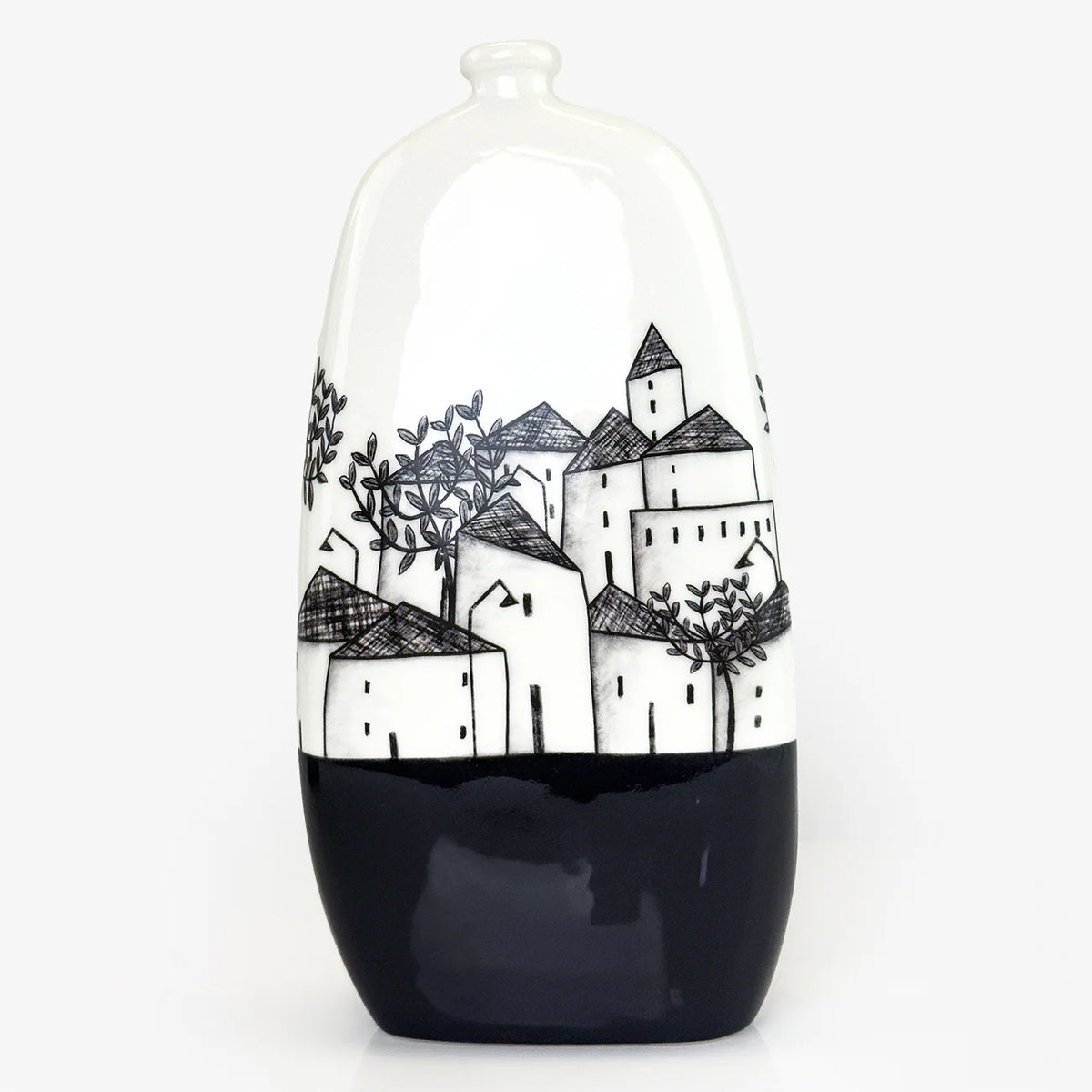 A glossy ceramic vase with a white upper body featuring a black hand-drawn village and tree pattern, and a solid black lower half, set against a plain white background.