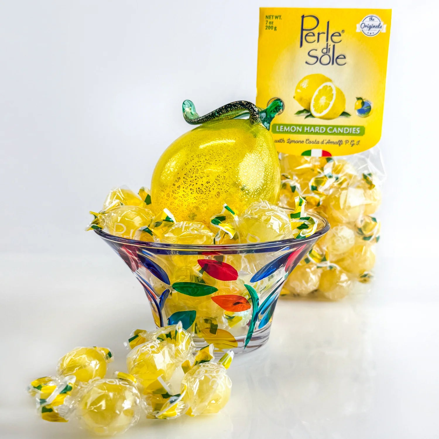 Lemon-colored candy bowl with Italian hard candies, decorative glass bowl from My Italian Decor, filled with colorful sweets.