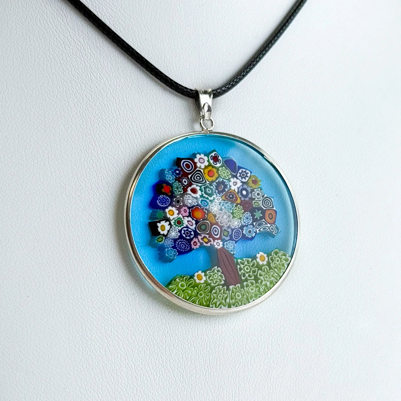 Sterling silver Millefiori Pendant Tree of Life necklace, 1.3-inch diameter, featuring colorful glass mosaic design on a silver rim.