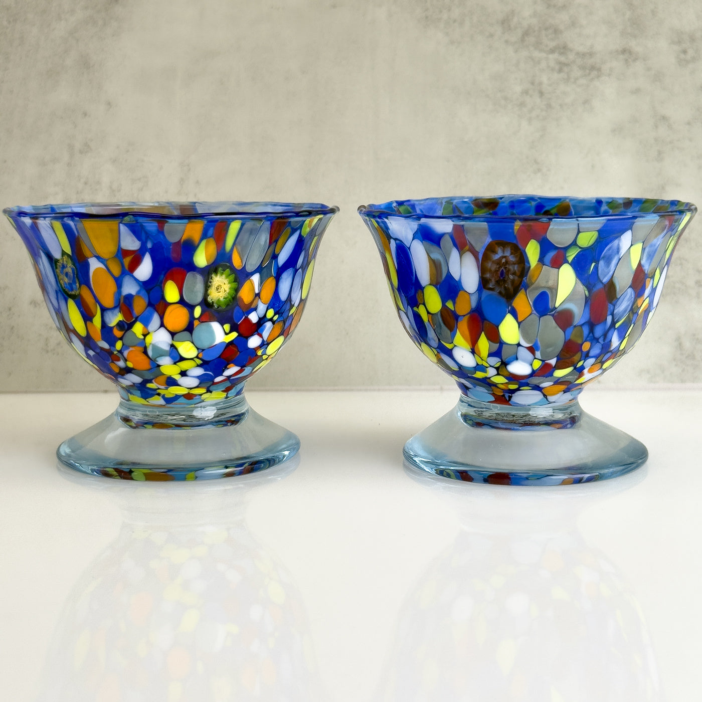 Set of two Italian glass footed ice cream bowls with elegant design, perfect for serving desserts in a stylish way.