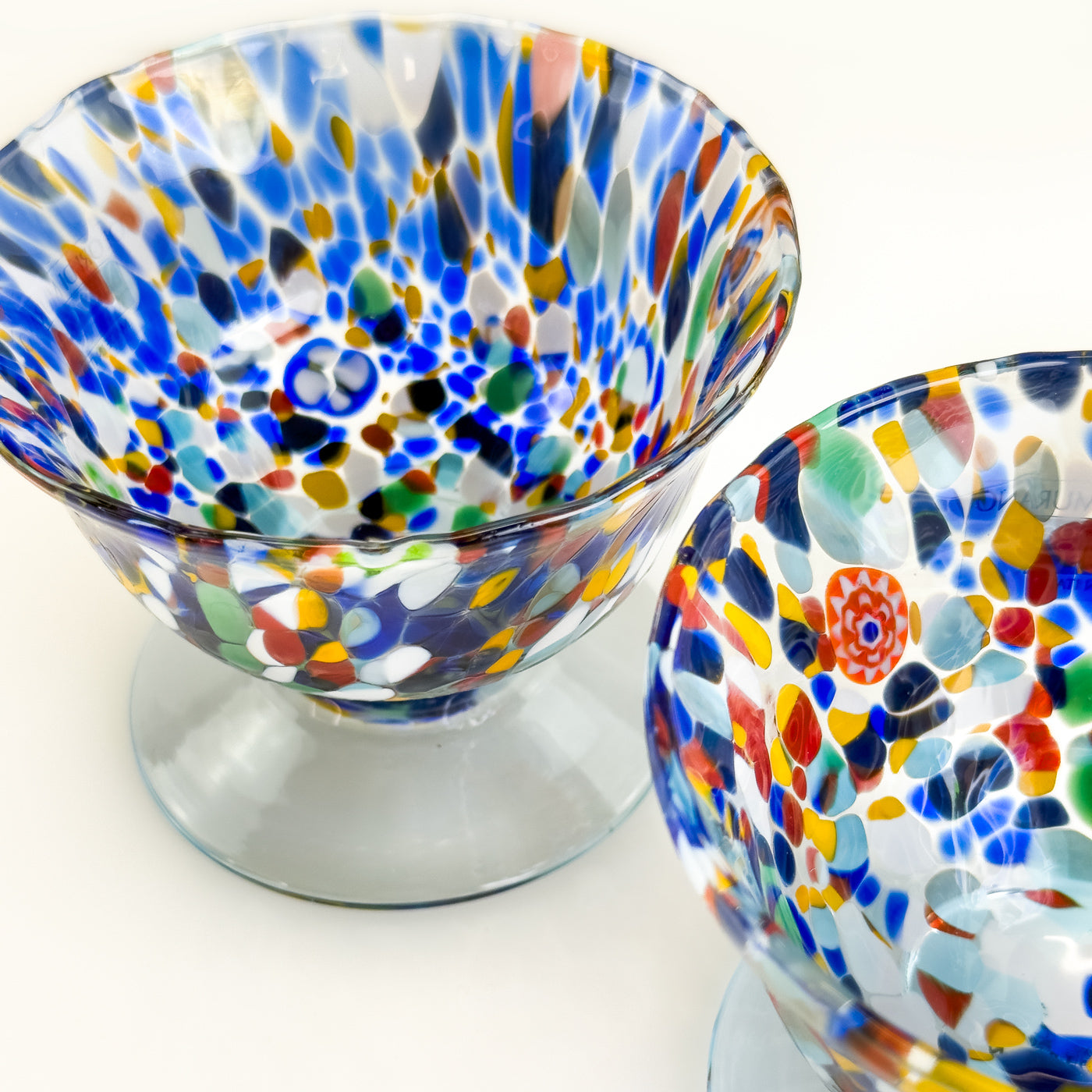 Set of two Italian glass footed ice cream bowls with elegant design, perfect for serving dessert in a stylish way.