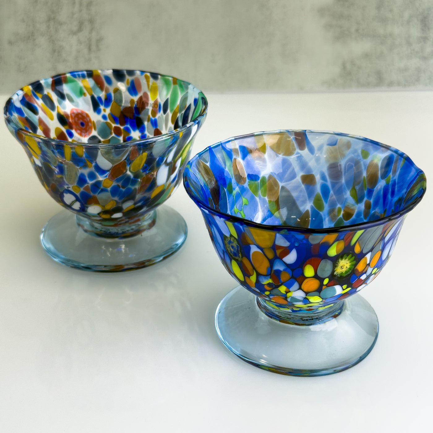 Set of two Italian glass footed bowls for ice cream, elegant and clear, perfect for serving desserts in a stylish setting.