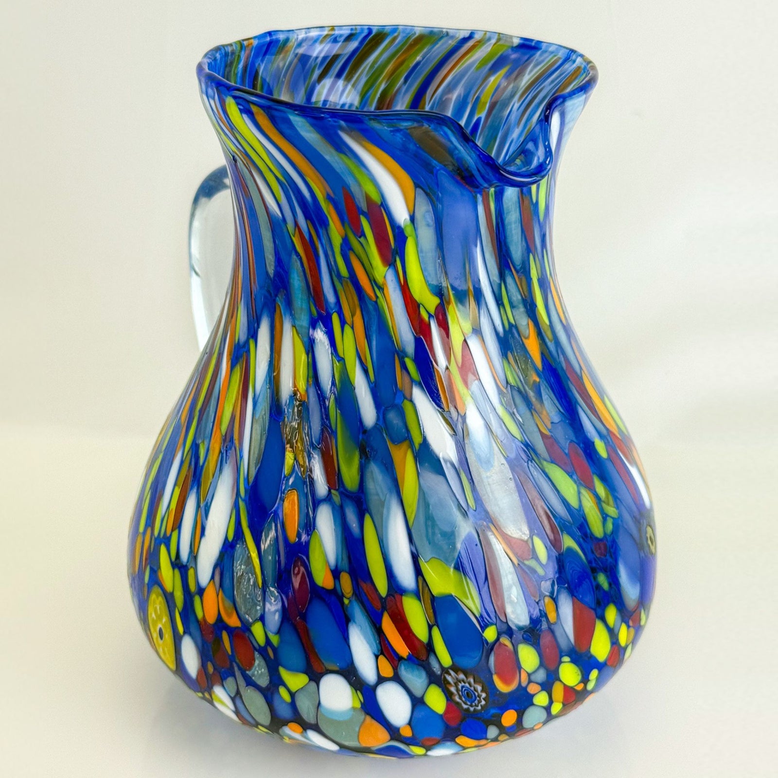 Round glass pitcher with confetti blue design by MZ, made in Italy, suitable for serving beverages in a stylish way.