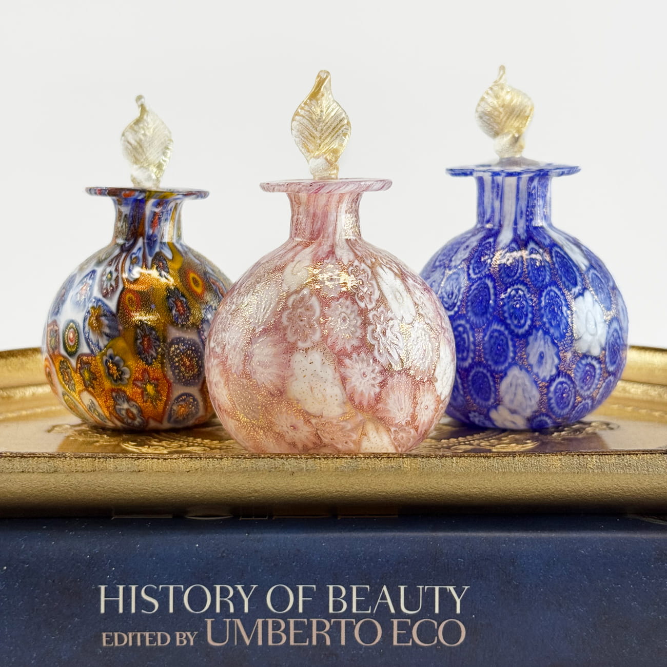 Millefiori decorative perfume bottle with 24k gold foil from Murano, Italy, featuring colorful glass craftsmanship.