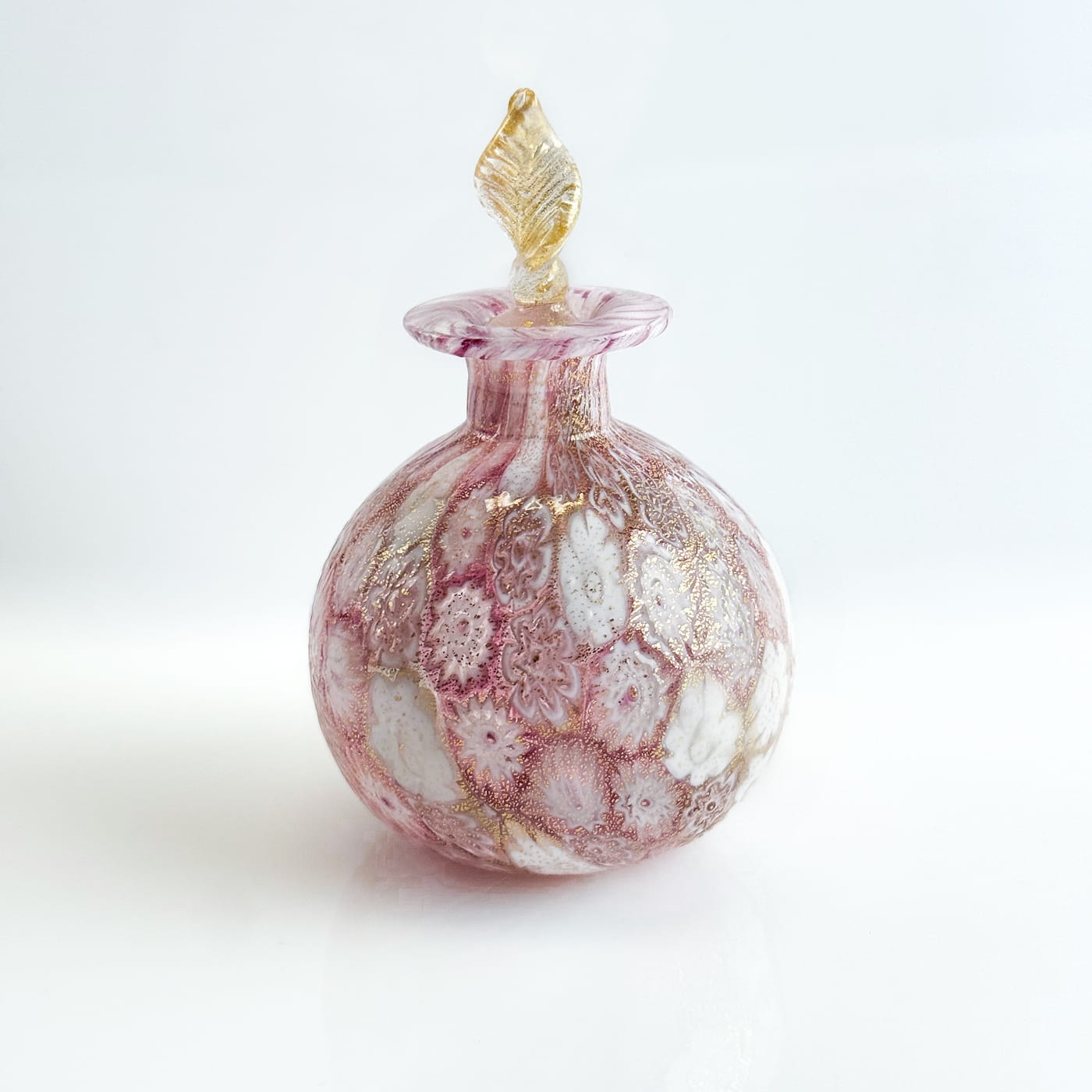Millefiori decorative perfume bottle with 24k gold foil from Murano, Italy, featuring colorful glass craftsmanship.