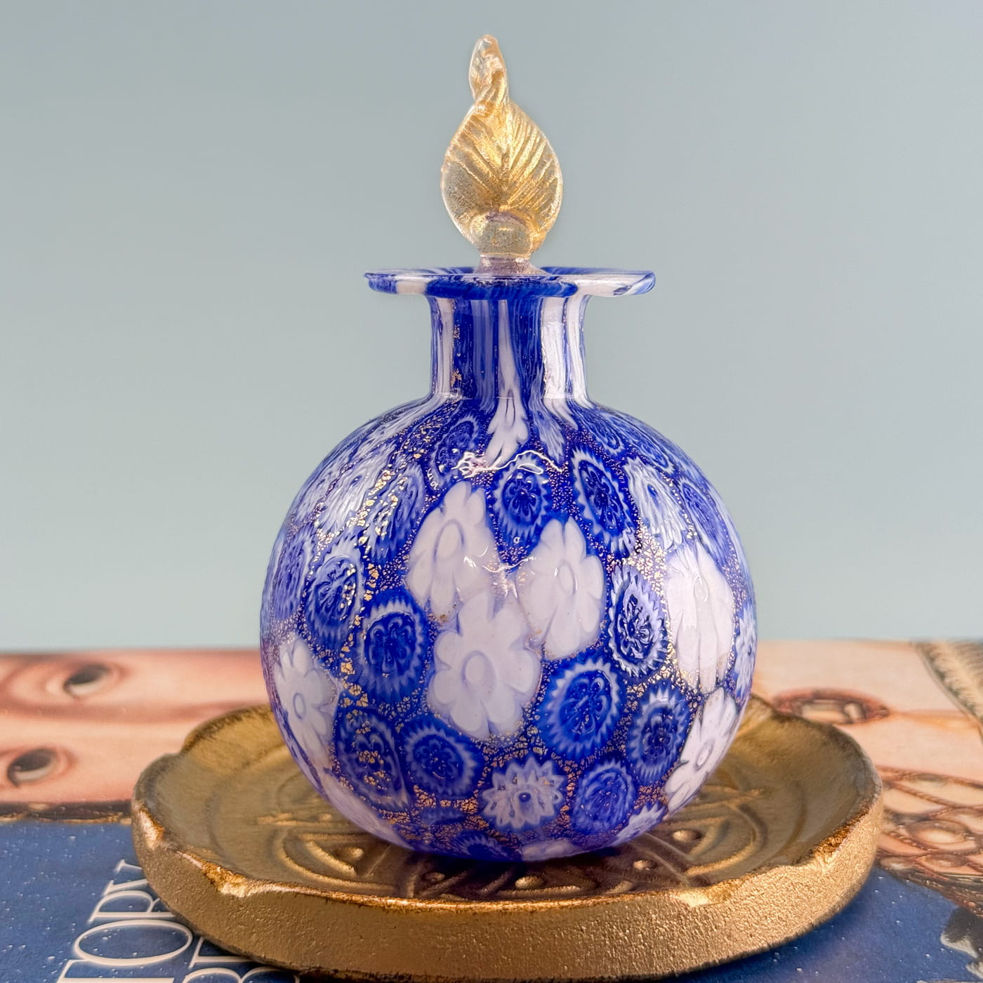 Millefiori decorative perfume bottle with 24k gold foil from Murano, Italy, featuring colorful glass craftsmanship.