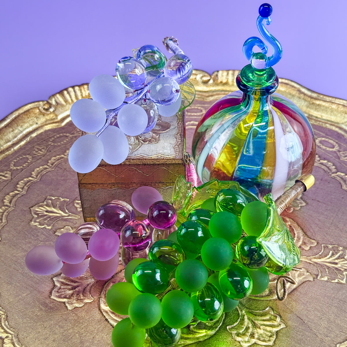 Colorful Murano glass grape cluster, small artificial flora from Italy, featuring multiple vibrant colors and realistic glass grapes.