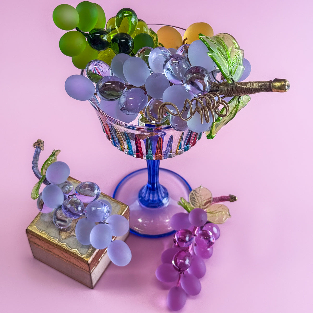 Large Murano glass grape cluster from Italy, realistic artificial grape flora with vibrant purple grapes and green leaves.