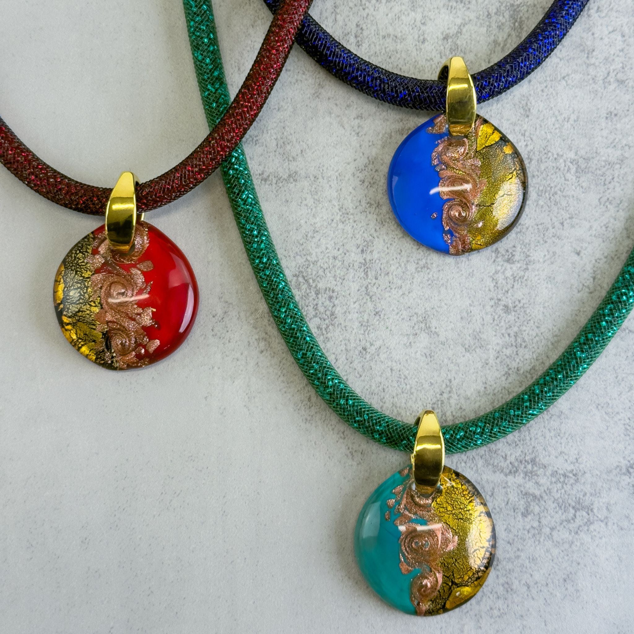 Large round Murano glass pendant necklace featuring colorful, chunky Italian charms and pendants on a silver chain.
