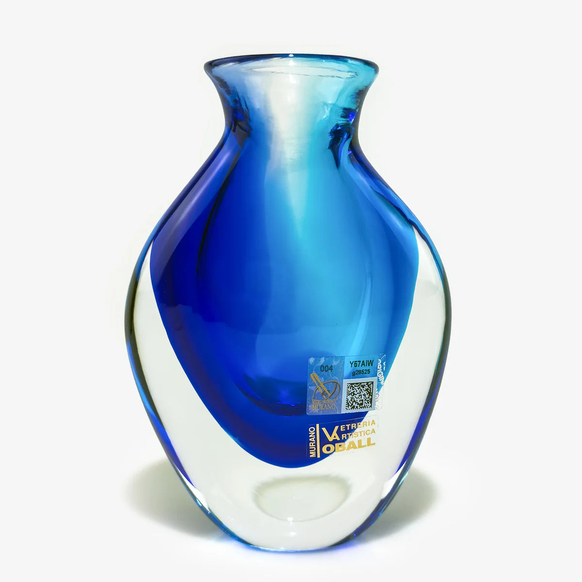 Two hand-blown glass vases with organic curved shapes, one featuring a gradient of red, dark brown, and blue over a clear base, and the other in a vibrant blue and white swirl pattern, set against a plain white background.