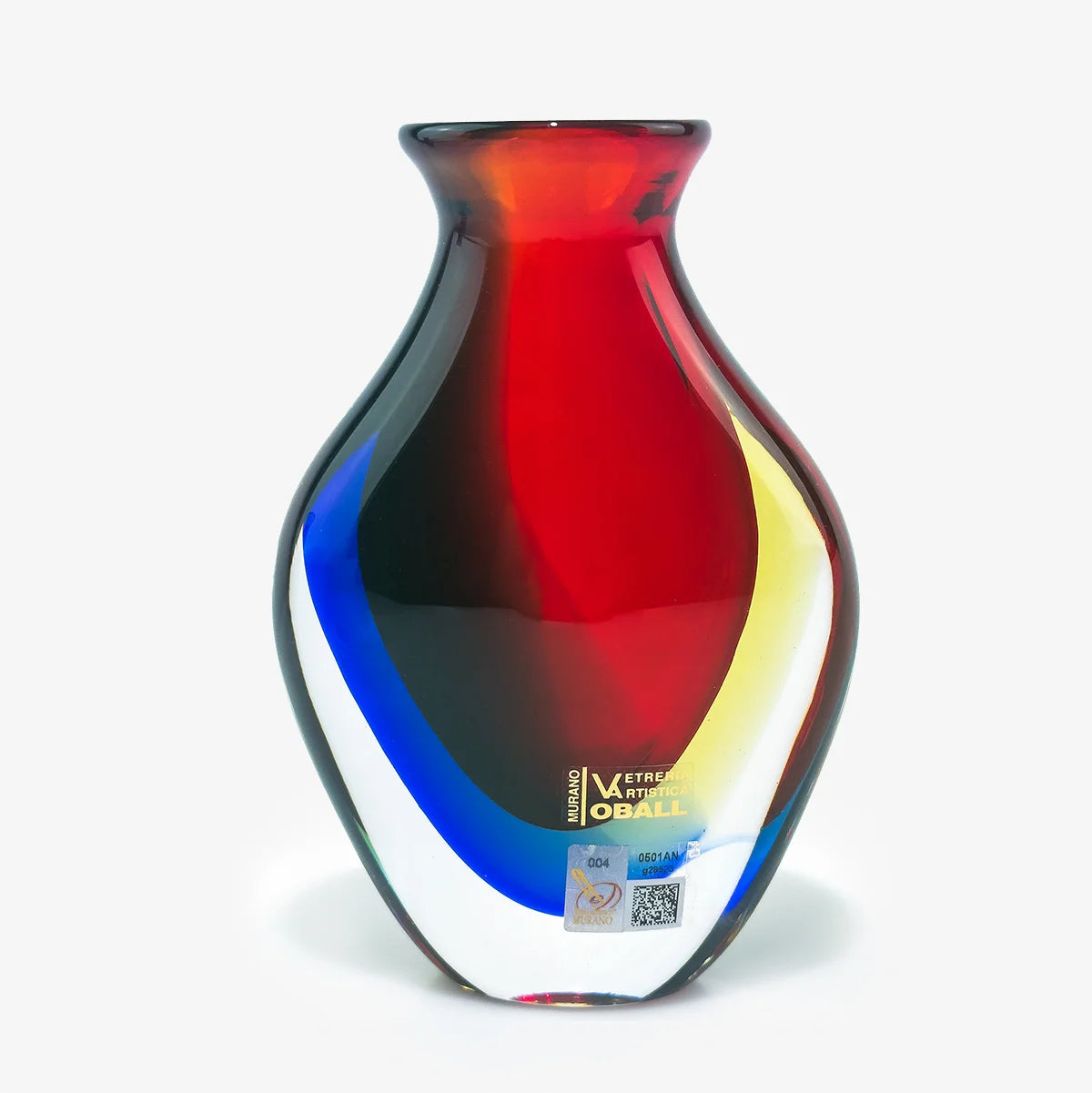 A hand-blown glass vase with a rounded body, featuring a color-shifting design that transitions from red to black, blue, and yellow, with a small gold 'Vitreous Obale' logo near the base.