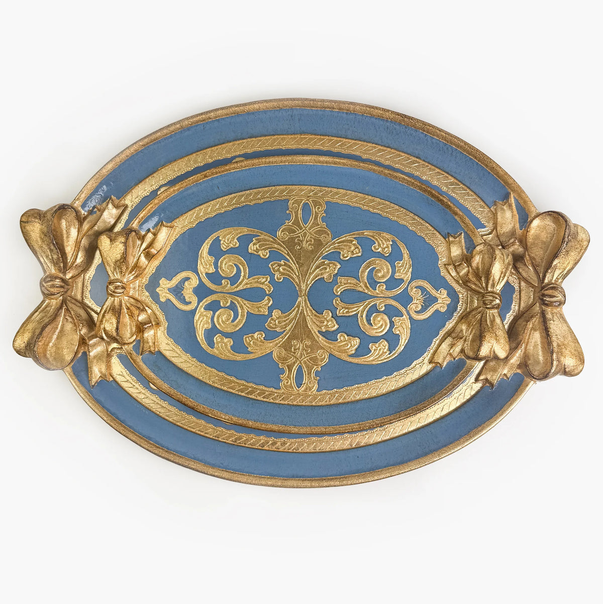 Two carved oval, dusty blue and gold Florentine trays with a bow detail. A medium sized tray is set inside a large tray.