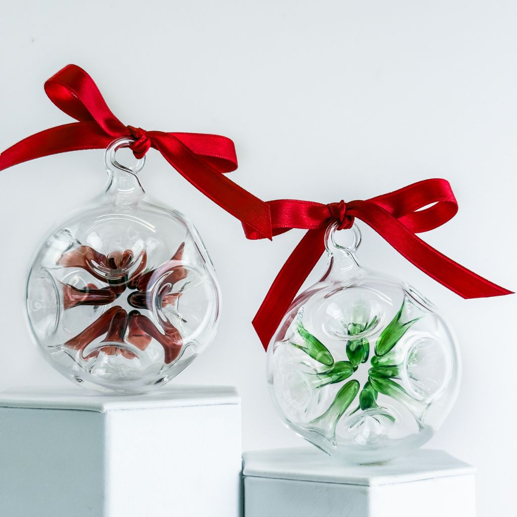 Clear glass holiday ornament with an internal colored star shape, made in Italy by My Italian Decor.