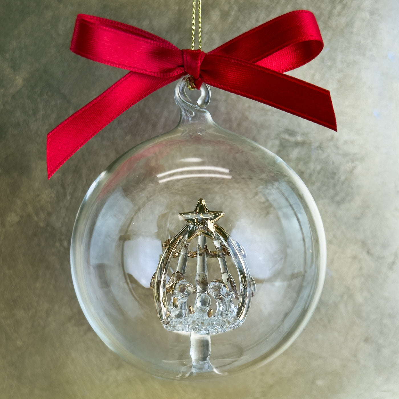 Clear glass nativity ornament from My Italian Decor holiday collection featuring a detailed nativity scene inside.