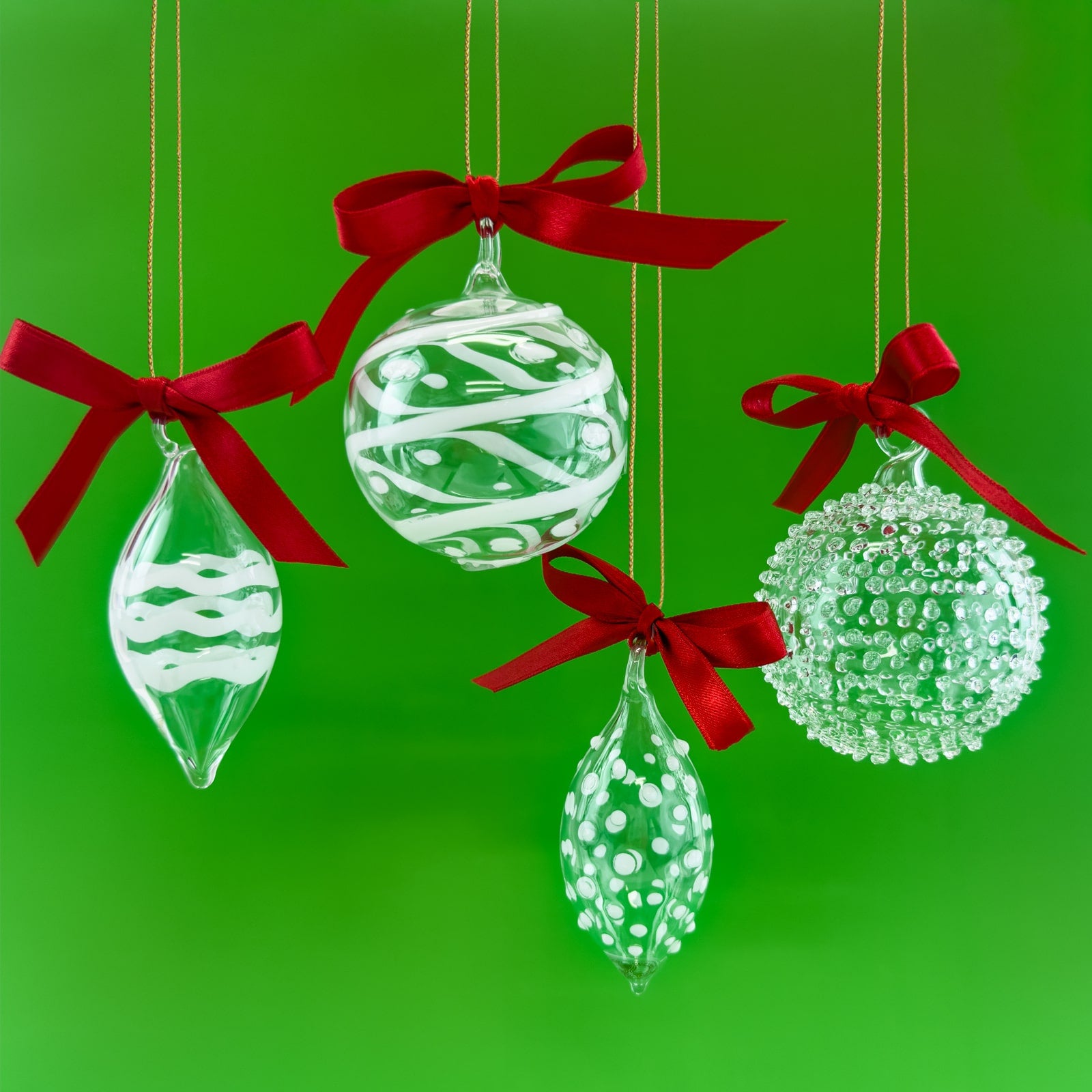 Set of four blown clear glass holiday ornaments with textured surface, made in Italy, by My Italian Decor.